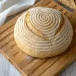Gluten Free Sourdough Bread: The Ultimate Guide for Delicious Homemade Loaves 7 Decorative round gluten free sourdough bread on a folded kitchen towel