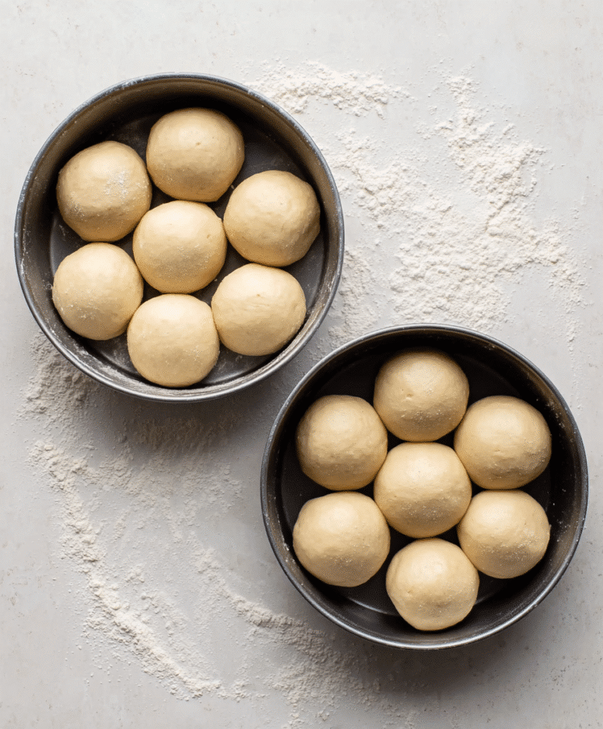 The Best Gluten-Free Dinner Rolls: Soft, Fluffy & Totally Irresistible 5 gluten-free dough balls in pans ready for baking